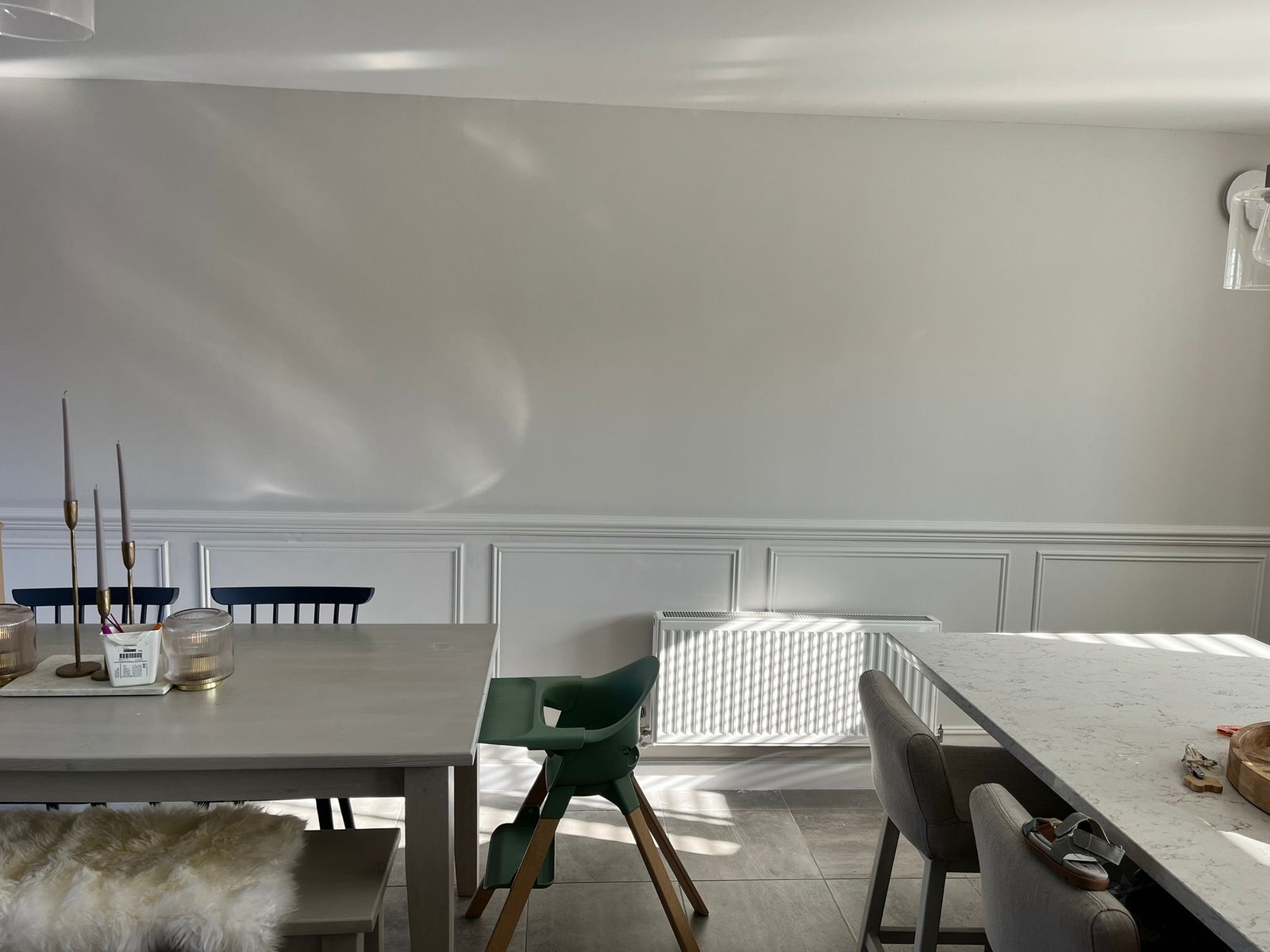 Bright dining area with white decorative wall panelling